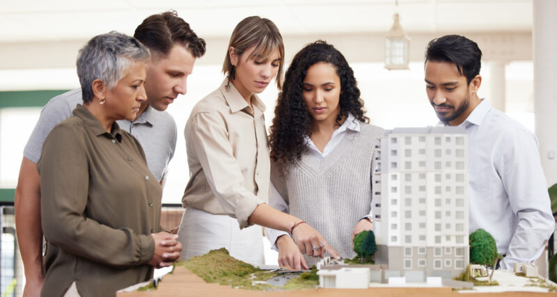 Investors analyzing an apartment model, which is a type of alternative investment.