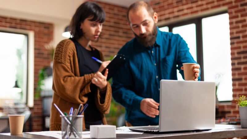 Two individuals looking into the available alternative investments that they can invest in