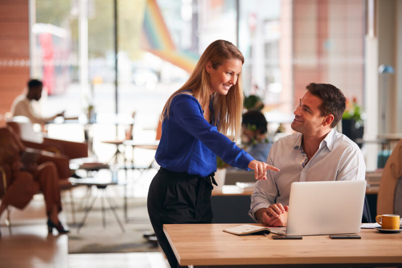 A man and a woman conversing on how to find businesses to invest in.