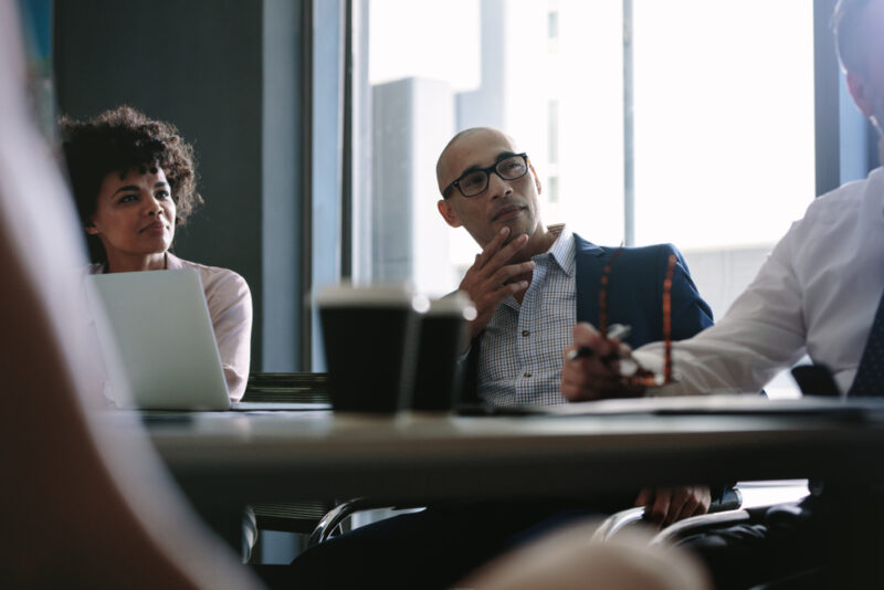 Man listening to discussion on alternative investments for accredited investors 