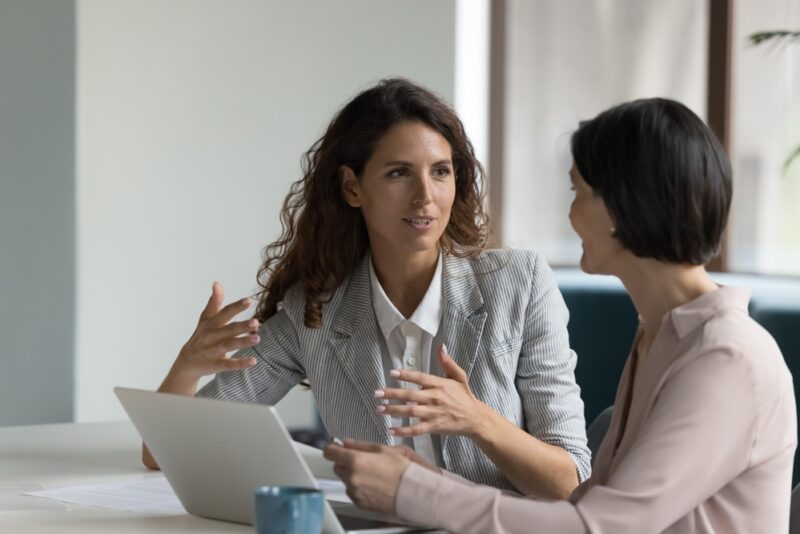 Woman explaining alternative investments to another woman