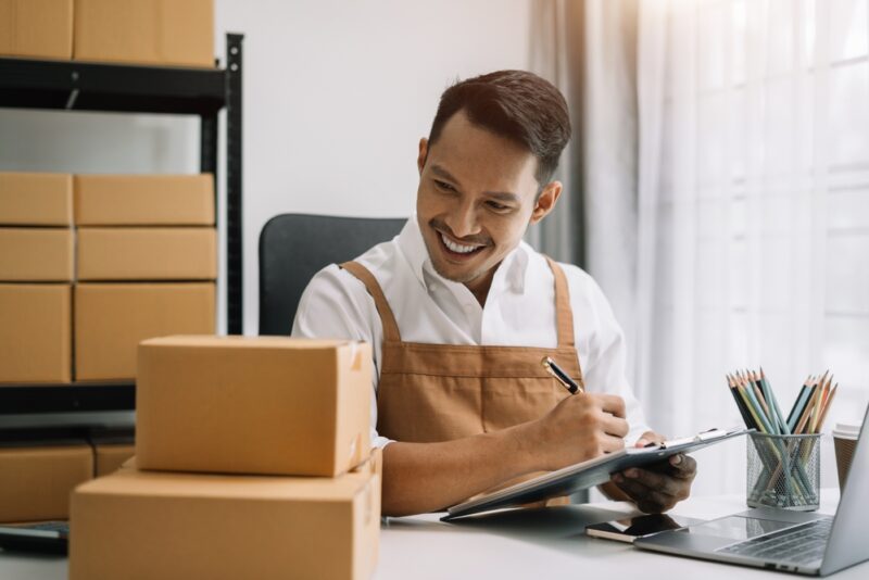 Online store owner writing eCommerce acronyms