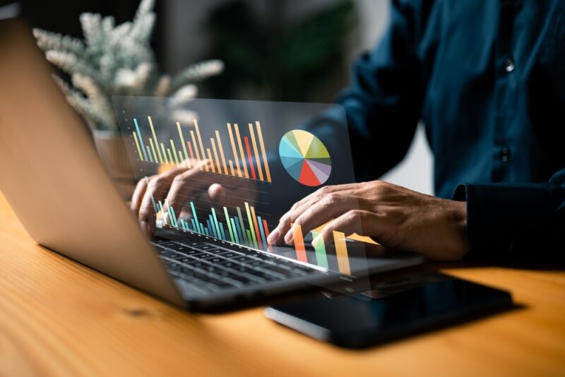 Man comparing best alternative investments using graphs