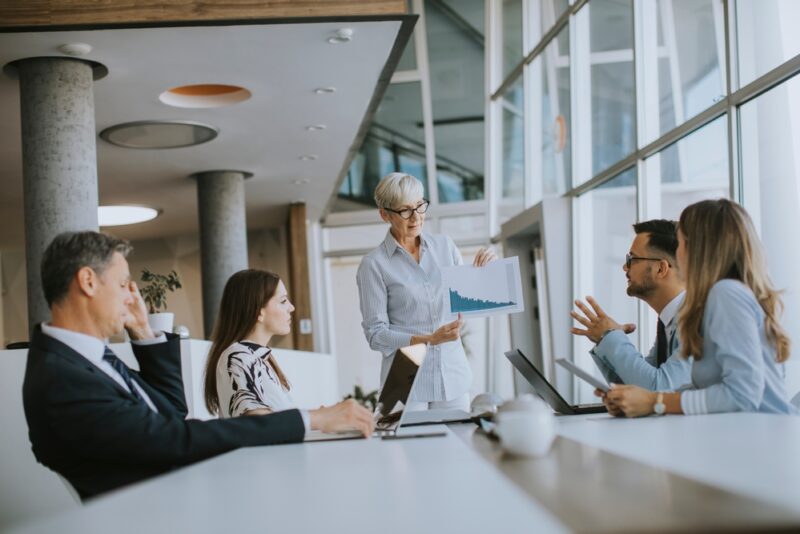 Woman explaining alternative investments to her colleagues