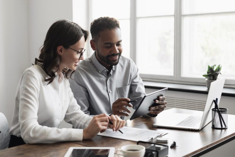 Partners discussing how to invest in small businesses online