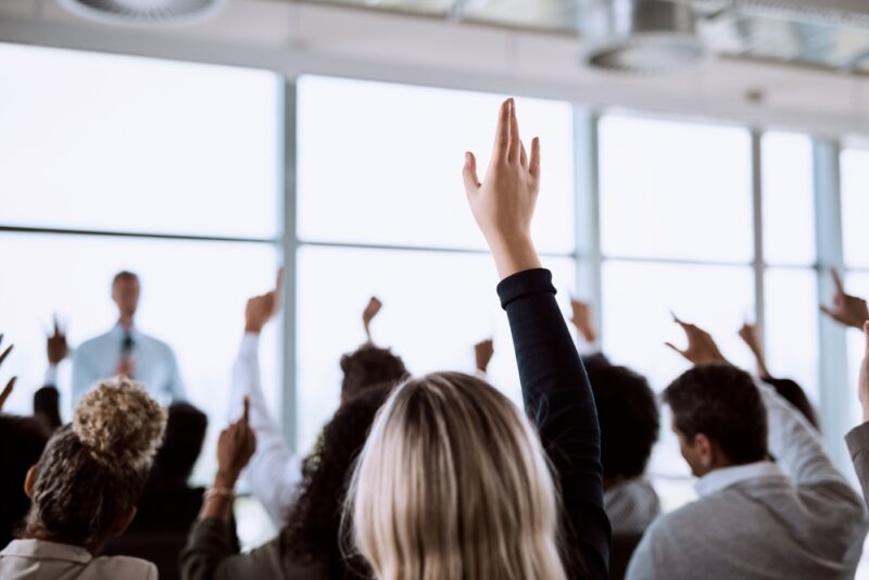 Investors raising their hands to ask a question