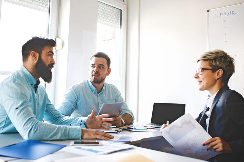 People discussing alternative investment opportunities in a meeting
