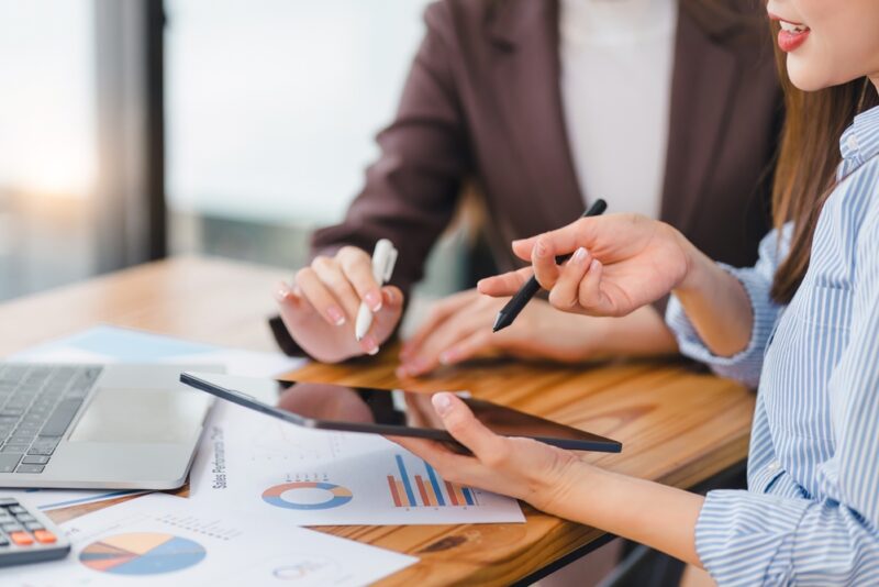 Two colleagues assessing different alternative investments