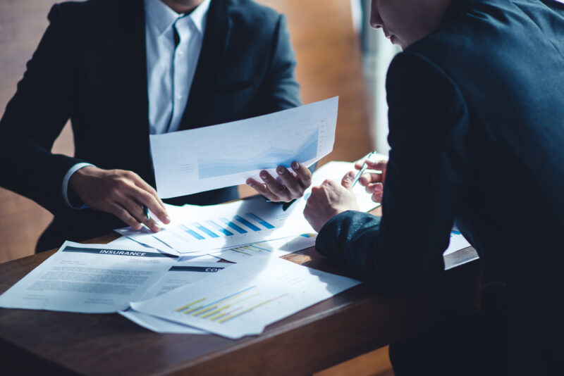 Two business partners conducting an analysis on investing in websites