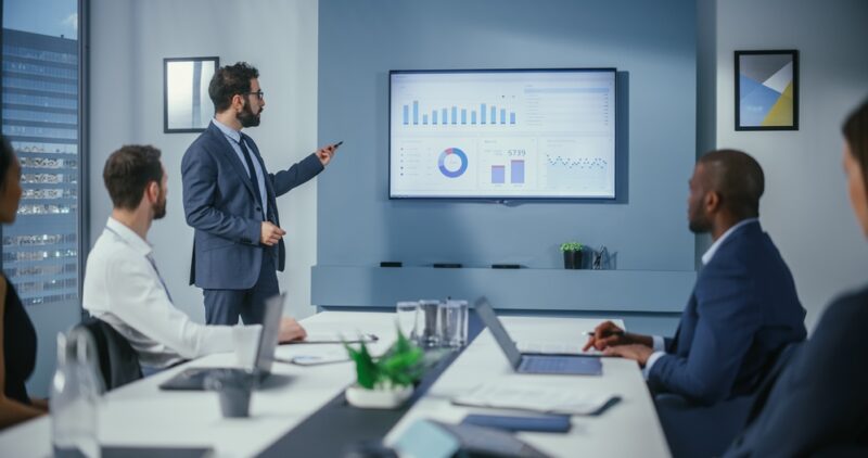 Man delivering presentation the strengths of Empire Flippers