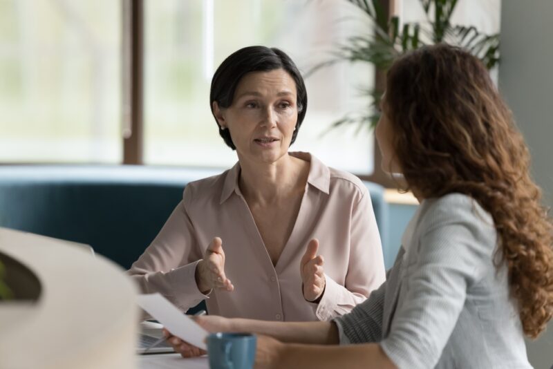 Woman explaining the rise of alternative investing to another woman